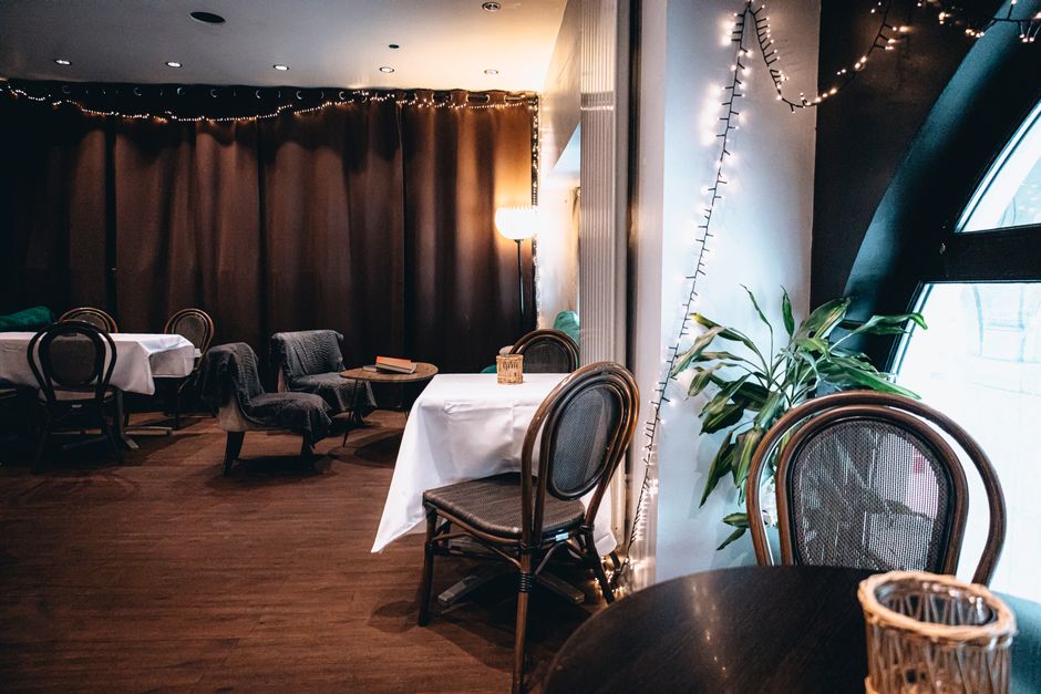 cozy tea shop interior with wooden furniture and soft lighting